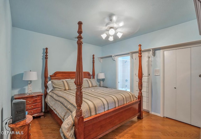 bedroom with ceiling fan, ensuite bath, and light hardwood / wood-style flooring