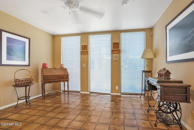 interior space featuring a textured ceiling and ceiling fan