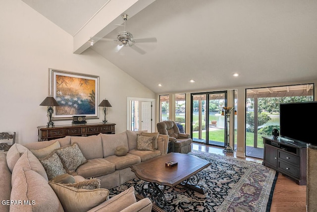 living room featuring lofted ceiling with beams, wood-type flooring, and ceiling fan