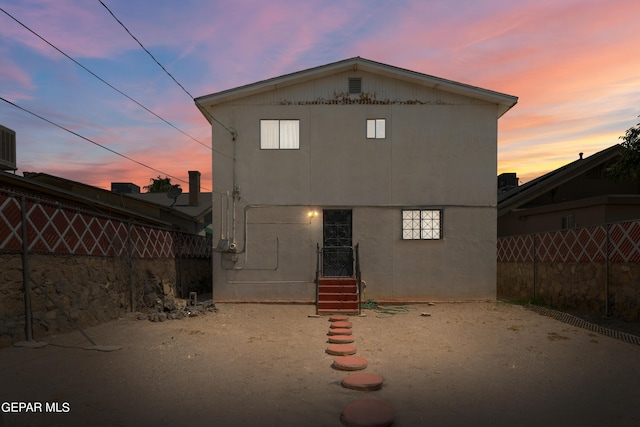 view of back house at dusk