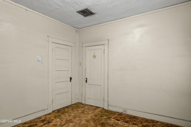 unfurnished room with carpet floors and a textured ceiling