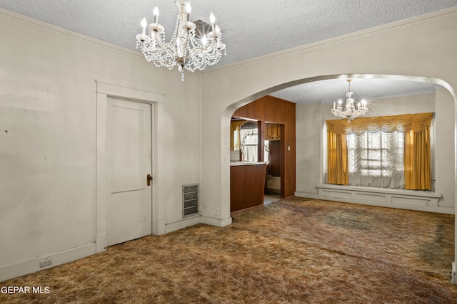 unfurnished dining area with crown molding, carpet floors, a notable chandelier, and a textured ceiling