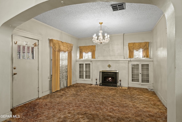 carpeted living room with crown molding, a chandelier, and a textured ceiling