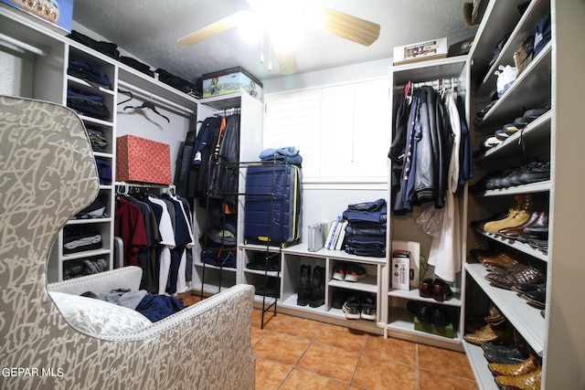 spacious closet featuring ceiling fan and tile patterned flooring