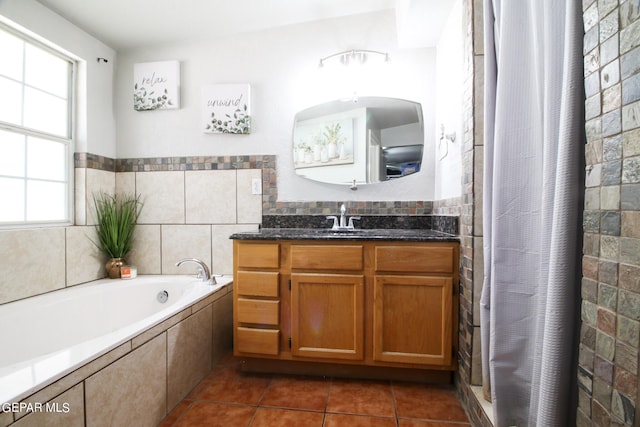 bathroom featuring vanity, tile patterned flooring, and plus walk in shower