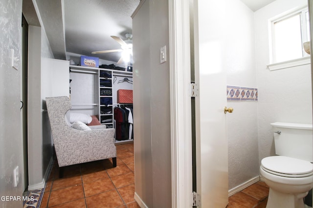 bathroom featuring toilet, tile patterned flooring, and ceiling fan