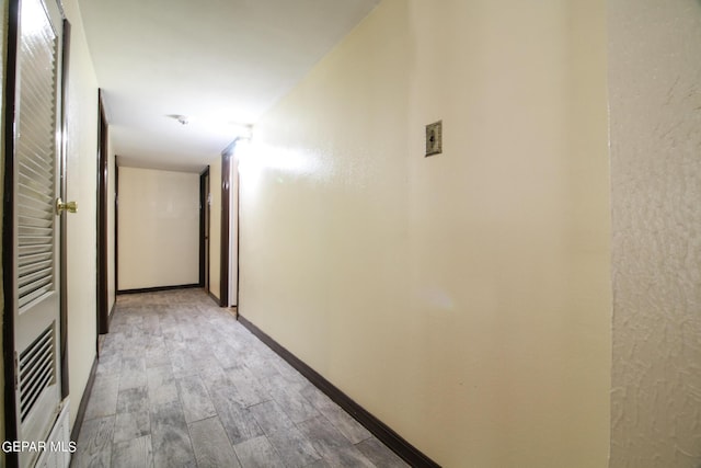 corridor with light wood-type flooring