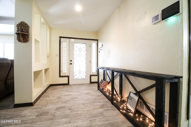 entrance foyer featuring light hardwood / wood-style flooring and plenty of natural light