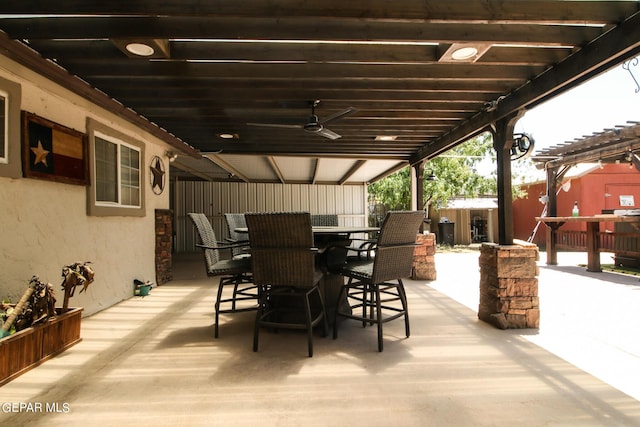 view of patio with a bar, ceiling fan, and a pergola