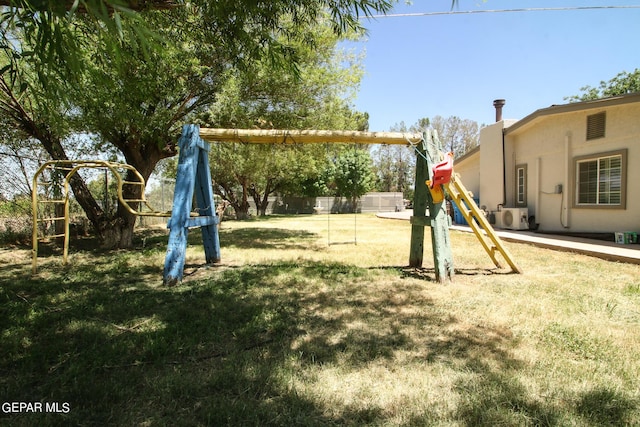 view of playground with ac unit and a yard