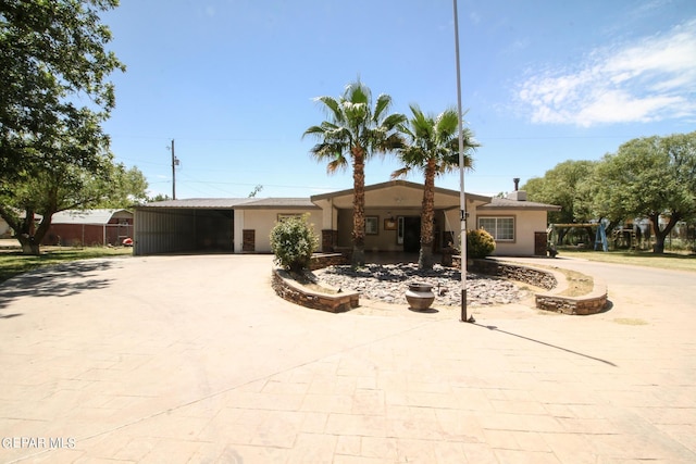 ranch-style home with a carport