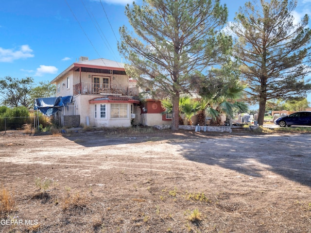 view of front of home featuring a balcony