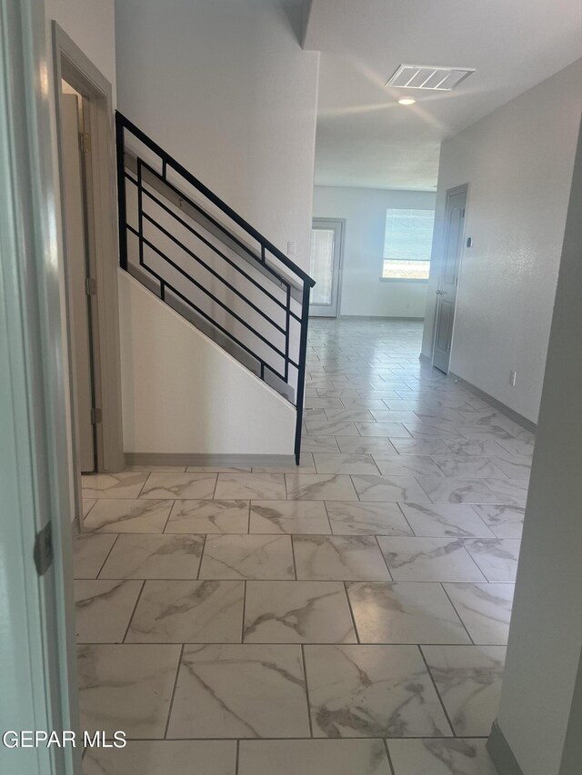 staircase with light tile patterned floors