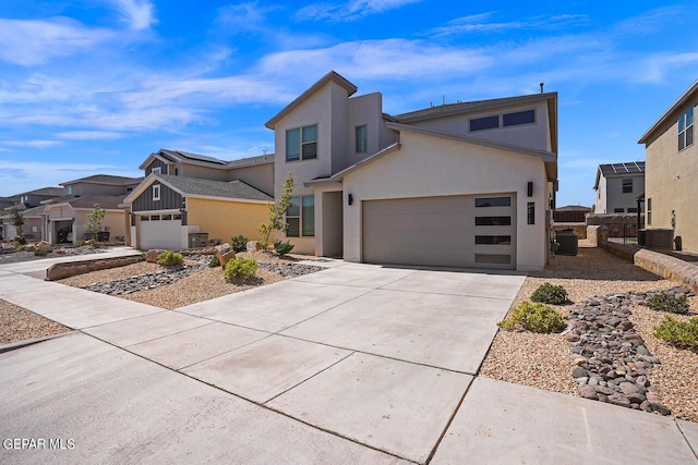 view of front of house with a garage and central air condition unit