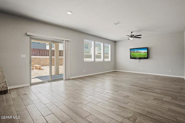 unfurnished living room with ceiling fan