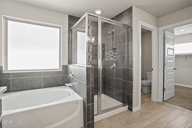 bathroom with shower with separate bathtub and toilet