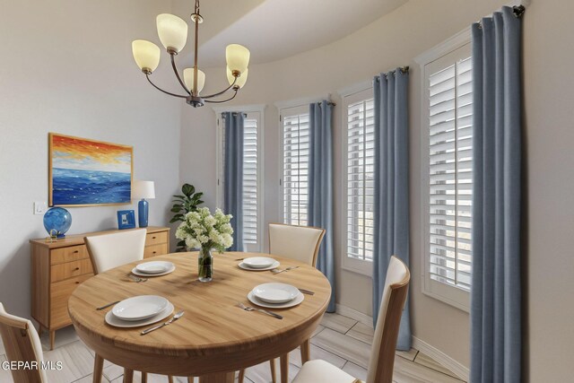 tiled dining area featuring an inviting chandelier and a healthy amount of sunlight