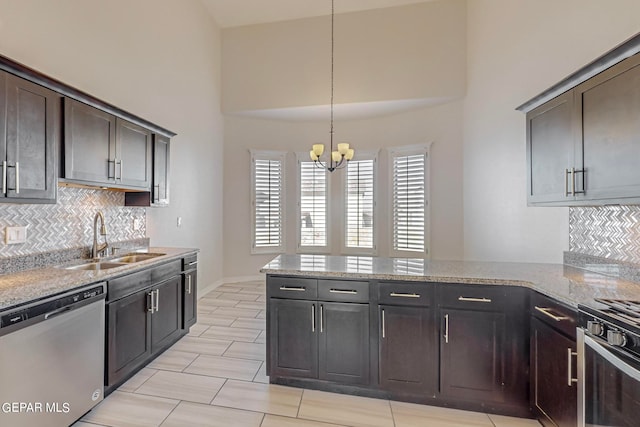 kitchen featuring tasteful backsplash, stainless steel dishwasher, light stone countertops, dark brown cabinetry, and sink