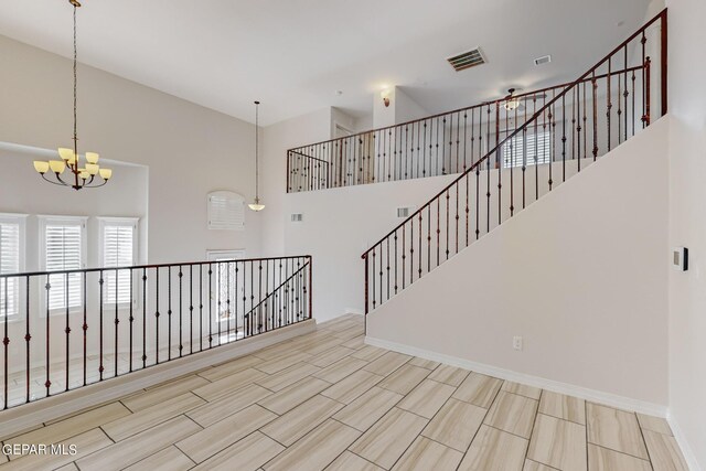 interior space featuring an inviting chandelier and a towering ceiling