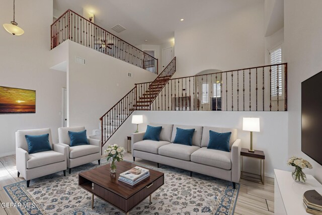 living room featuring a towering ceiling