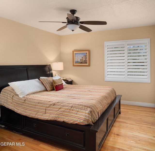 bedroom featuring ceiling fan and light hardwood / wood-style flooring