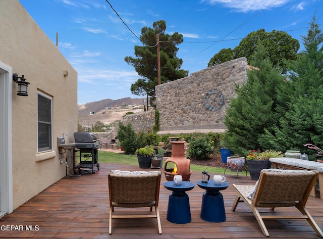 deck featuring a grill and a mountain view