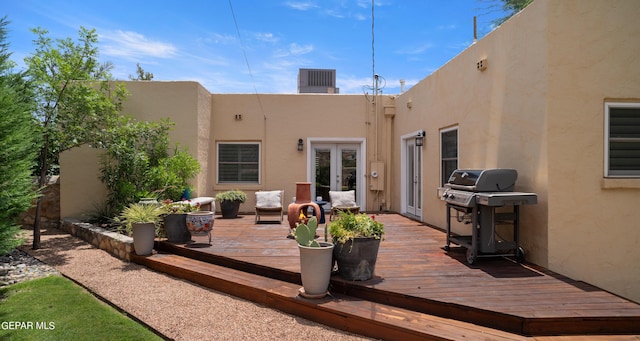 back of property featuring a wooden deck and french doors