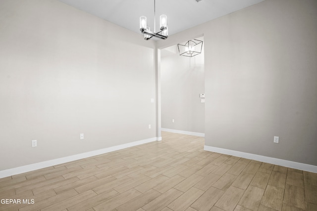 unfurnished dining area featuring light hardwood / wood-style floors and a notable chandelier