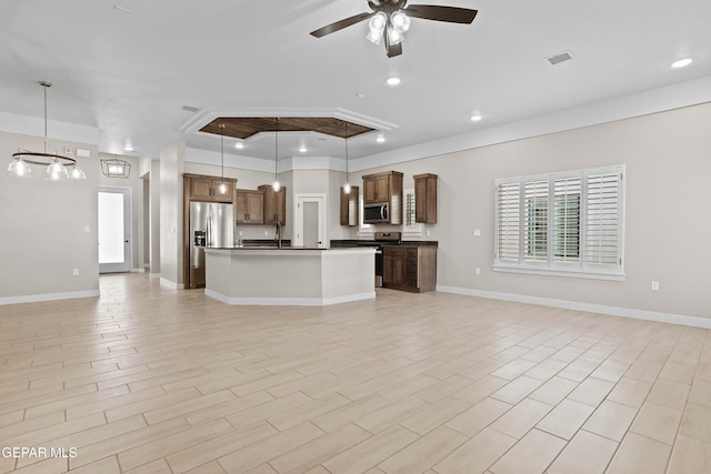 kitchen with pendant lighting, light hardwood / wood-style floors, and stainless steel appliances