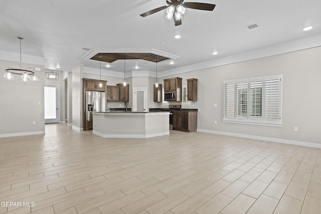 unfurnished living room with a ceiling fan, baseboards, visible vents, and ornamental molding