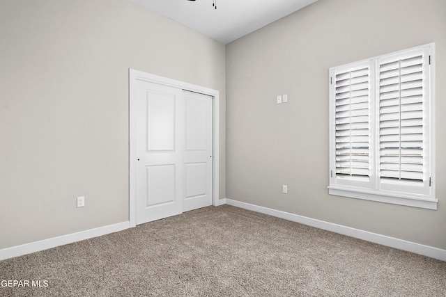 unfurnished bedroom with a closet and carpet floors