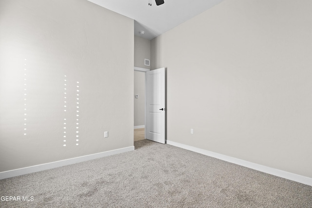 unfurnished bedroom with baseboards, carpet, and visible vents