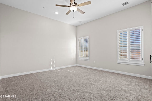 carpeted spare room with ceiling fan