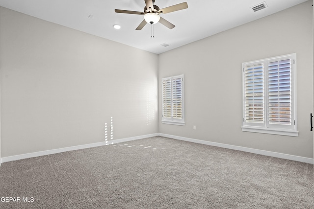 spare room featuring baseboards, carpet, a ceiling fan, and visible vents