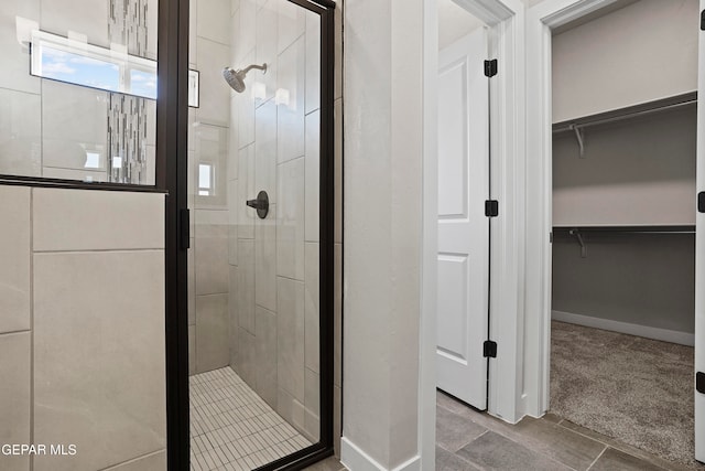 bathroom featuring a shower with shower door