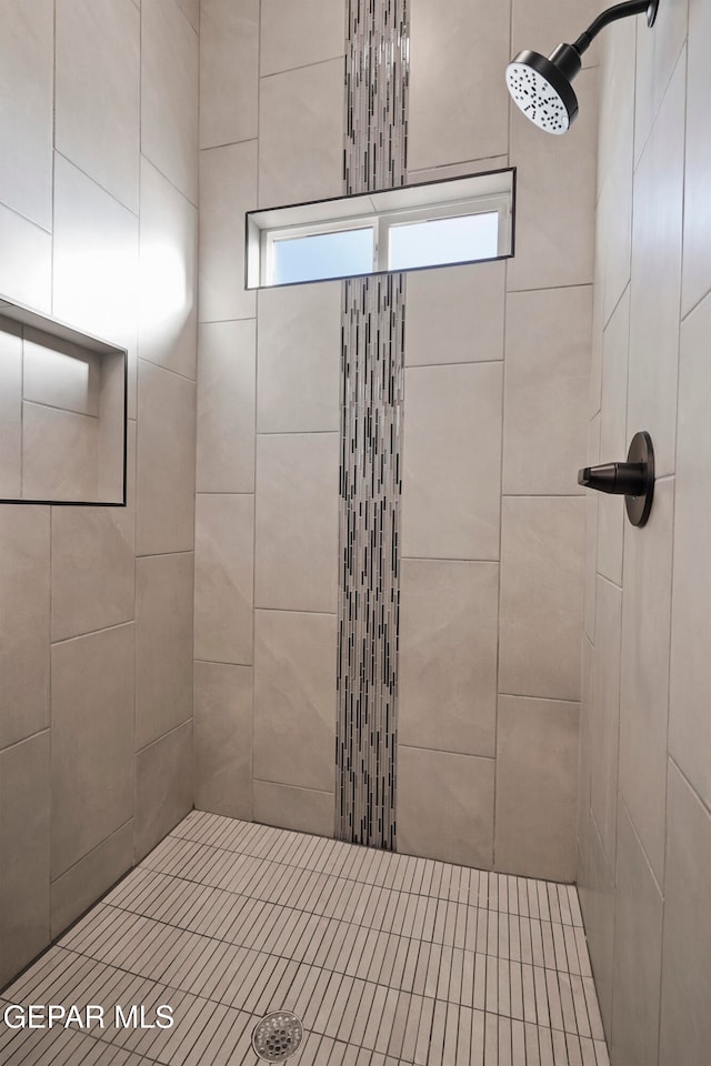 bathroom featuring tiled shower