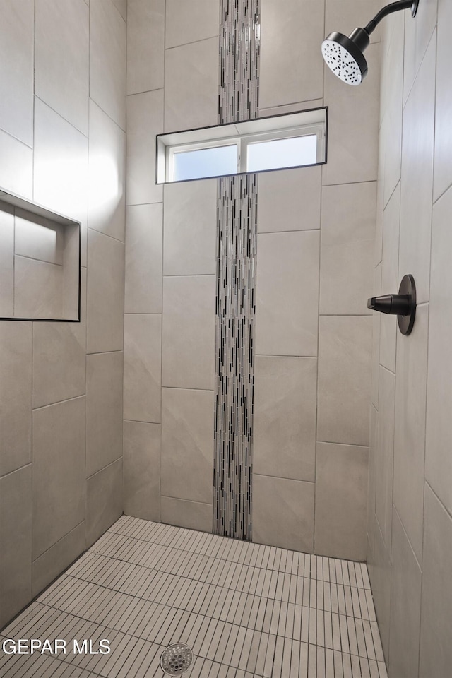 full bath with tiled shower