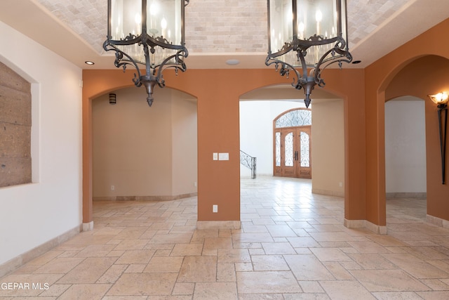 878 Cortona Pl, El Paso, TX 79928 - unfurnished dining area with a high ceiling, an inviting chandelier, and french doors