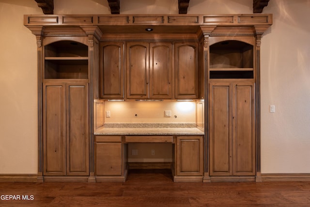 878 Cortona Pl, El Paso, TX 79928 - kitchen with built in desk, light stone countertops, and dark hardwood / wood-style floors