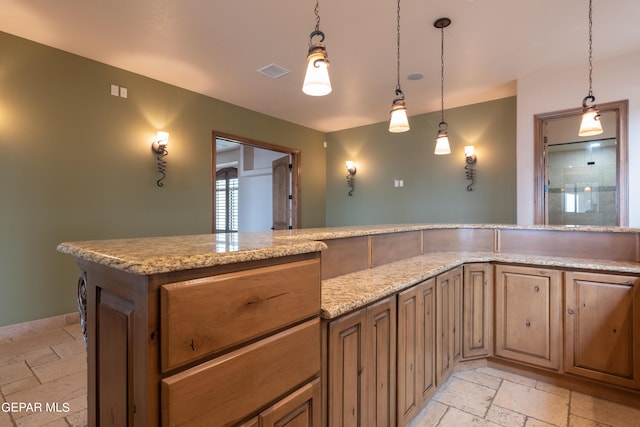 878 Cortona Pl, El Paso, TX 79928 - kitchen featuring light stone countertops and decorative light fixtures