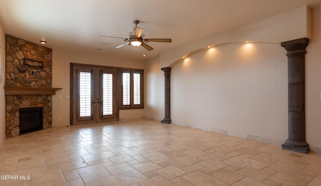878 Cortona Pl, El Paso, TX 79928 - unfurnished living room with ornate columns, a stone fireplace, ceiling fan, and french doors