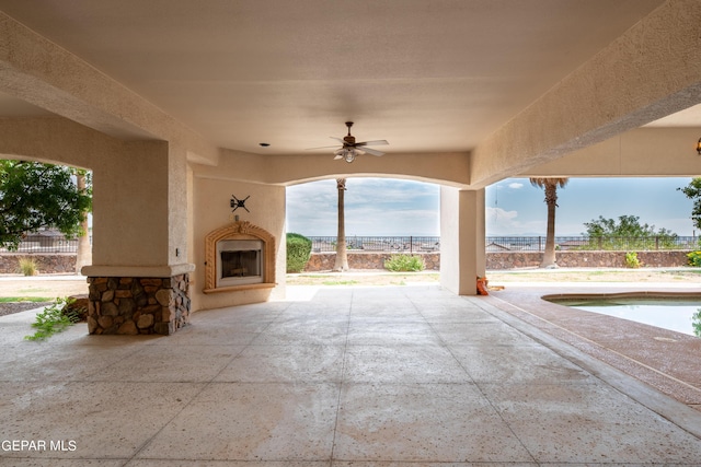 878 Cortona Pl, El Paso, TX 79928 - view of patio / terrace featuring ceiling fan, an outdoor fireplace, and a fenced in pool