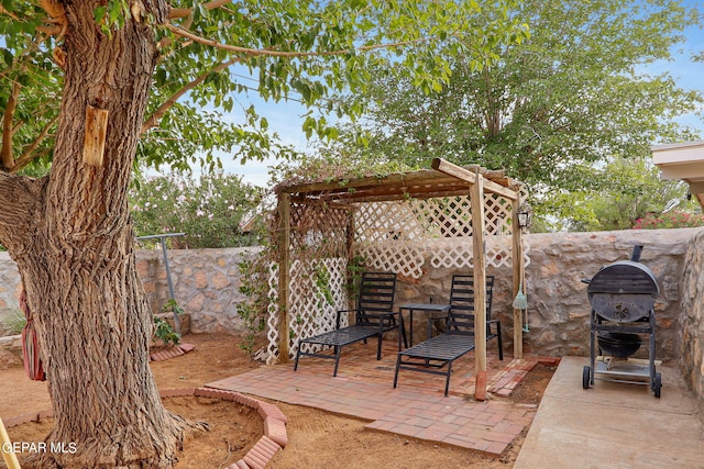 view of patio / terrace with a pergola and a grill