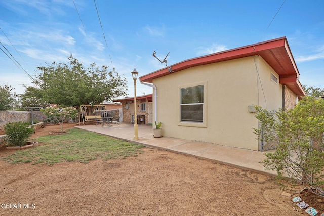 rear view of property with a patio area