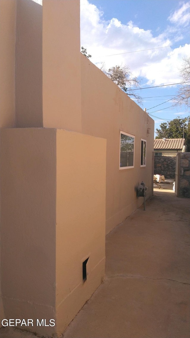 view of property exterior with a patio area