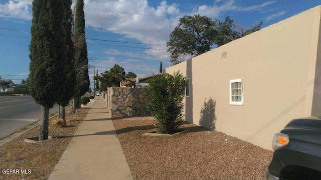 exterior space with fence and stucco siding