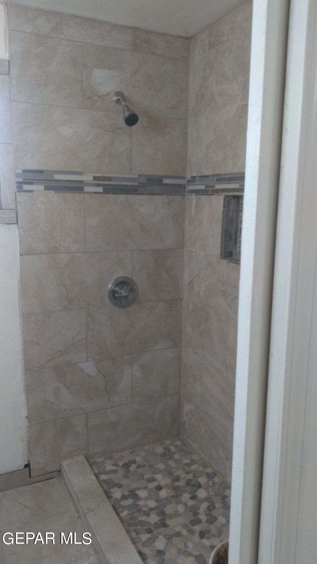 bathroom with tiled shower