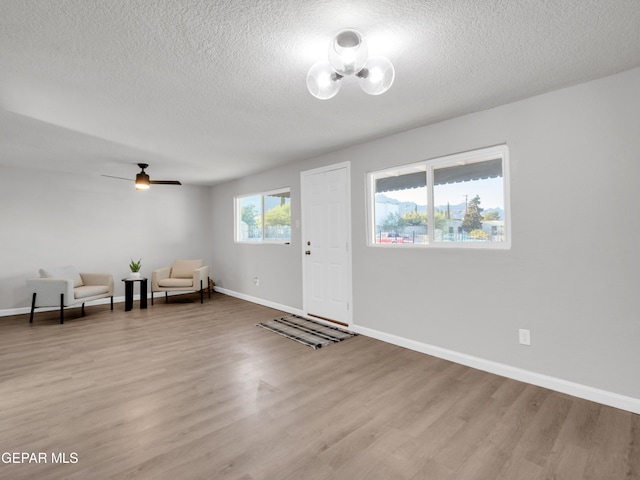 entryway featuring ceiling fan, a textured ceiling, and light hardwood / wood-style flooring