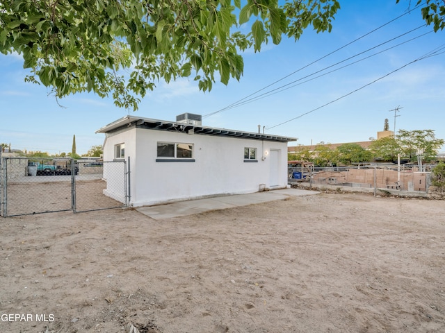 back of house with central AC