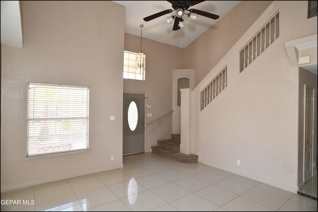 tiled entrance foyer featuring a high ceiling and ceiling fan